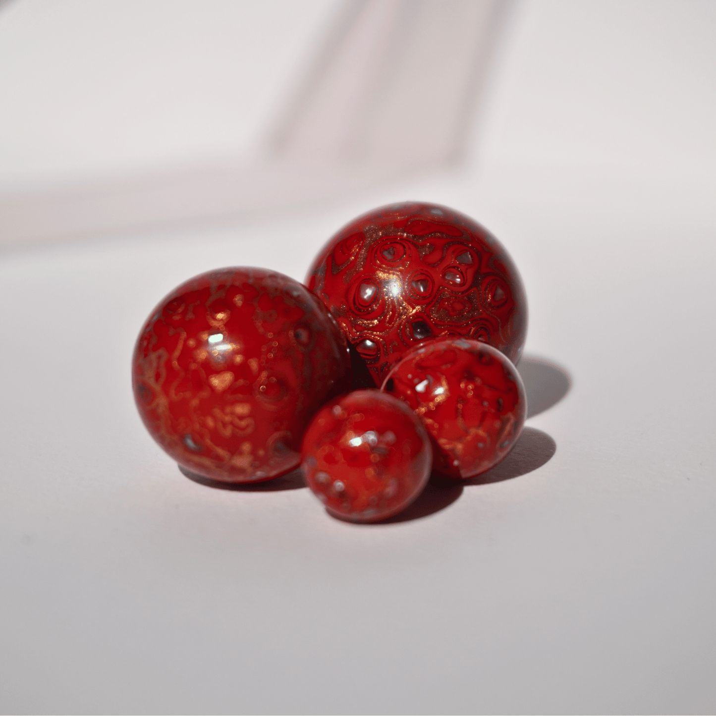 Blood Apricot ritual bead in sun-warmed orange-red gradient, botanical resin_cluster