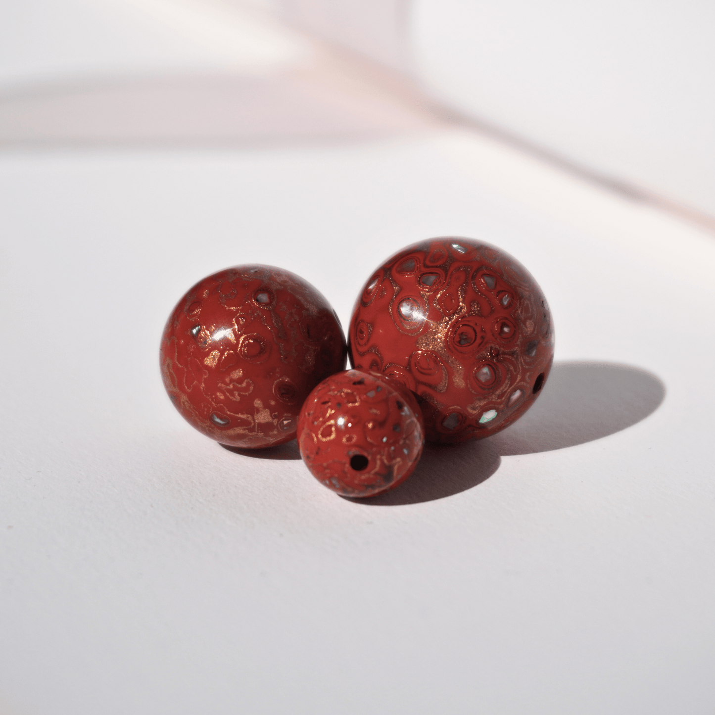 Blood Apricot ritual bead in sun-warmed orange-red gradient, botanical resin_trio