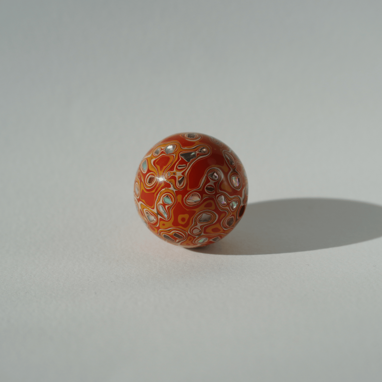 Flame Tangerine ritual bead in radiant orange with golden highlights, hand-polished resin_2