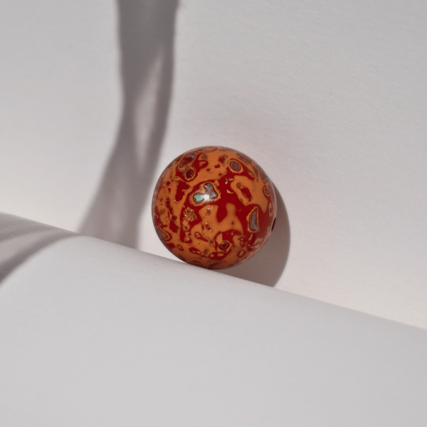 Flame_Tangerine_ritual_bead_in_radiant_orange_with_golden_highlights_hand-polished_resin