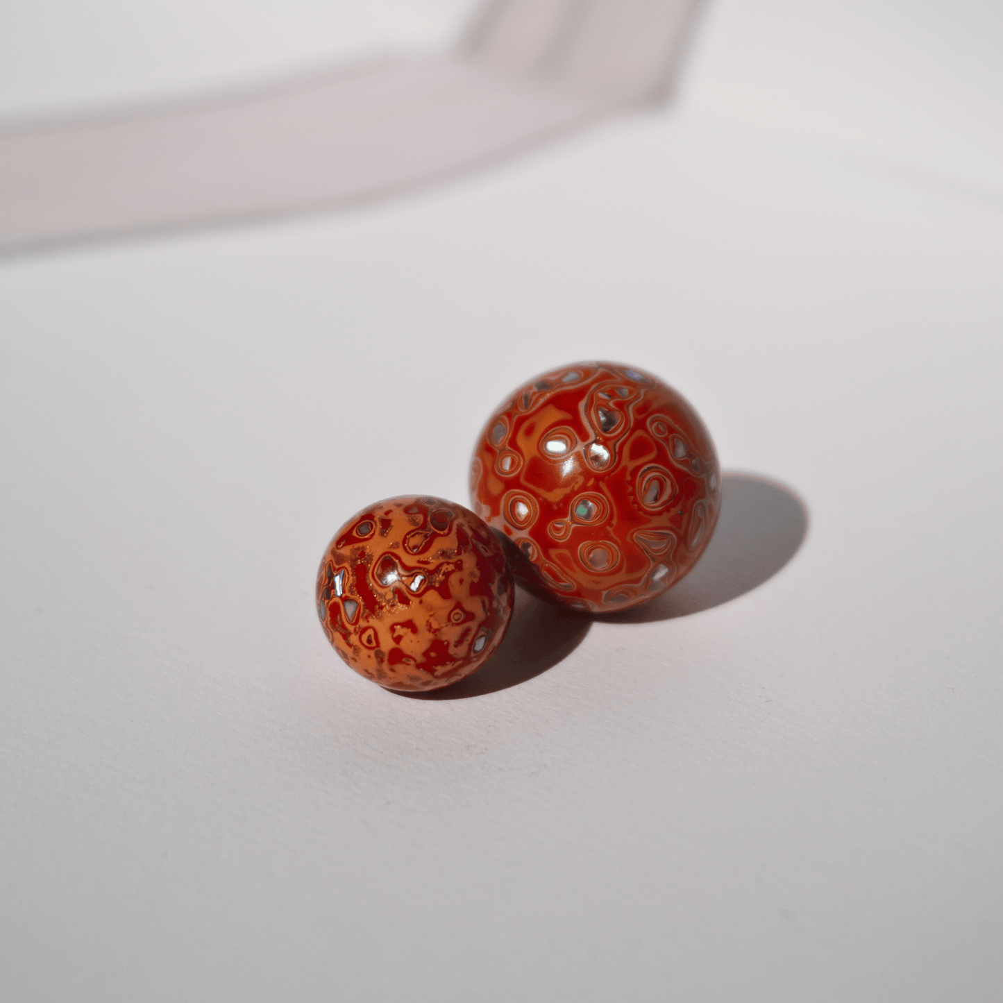 Flame Tangerine ritual bead in radiant orange with golden highlights, hand-polished resin_duo