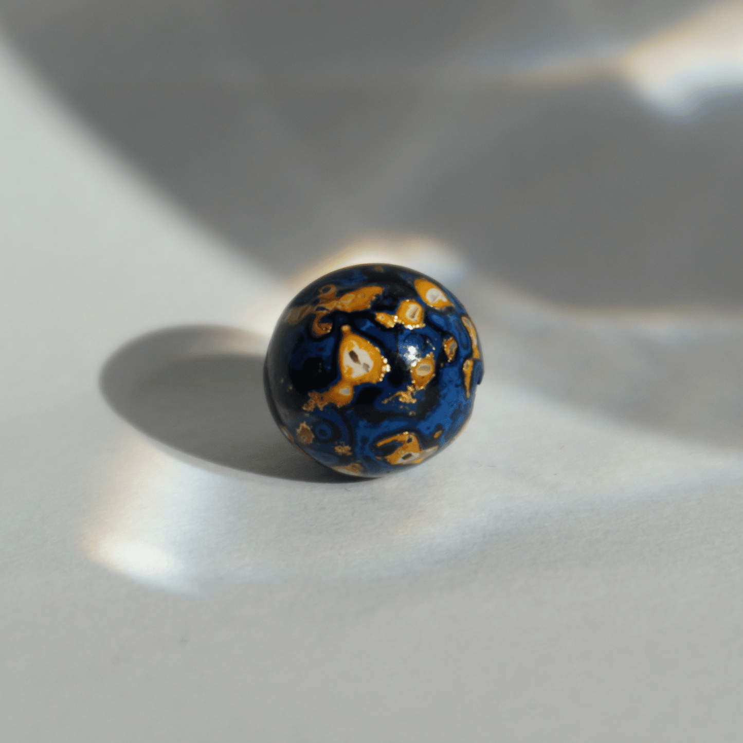 Indigo Desert ritual bead with celestial gold veining, handcrafted in plant-based resin_1