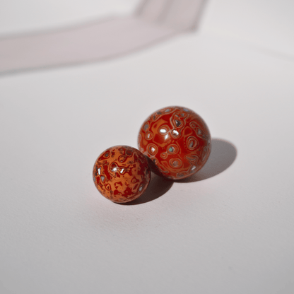 Flame Tangerine ritual bead in radiant orange with golden highlights, hand-polished resin_duo