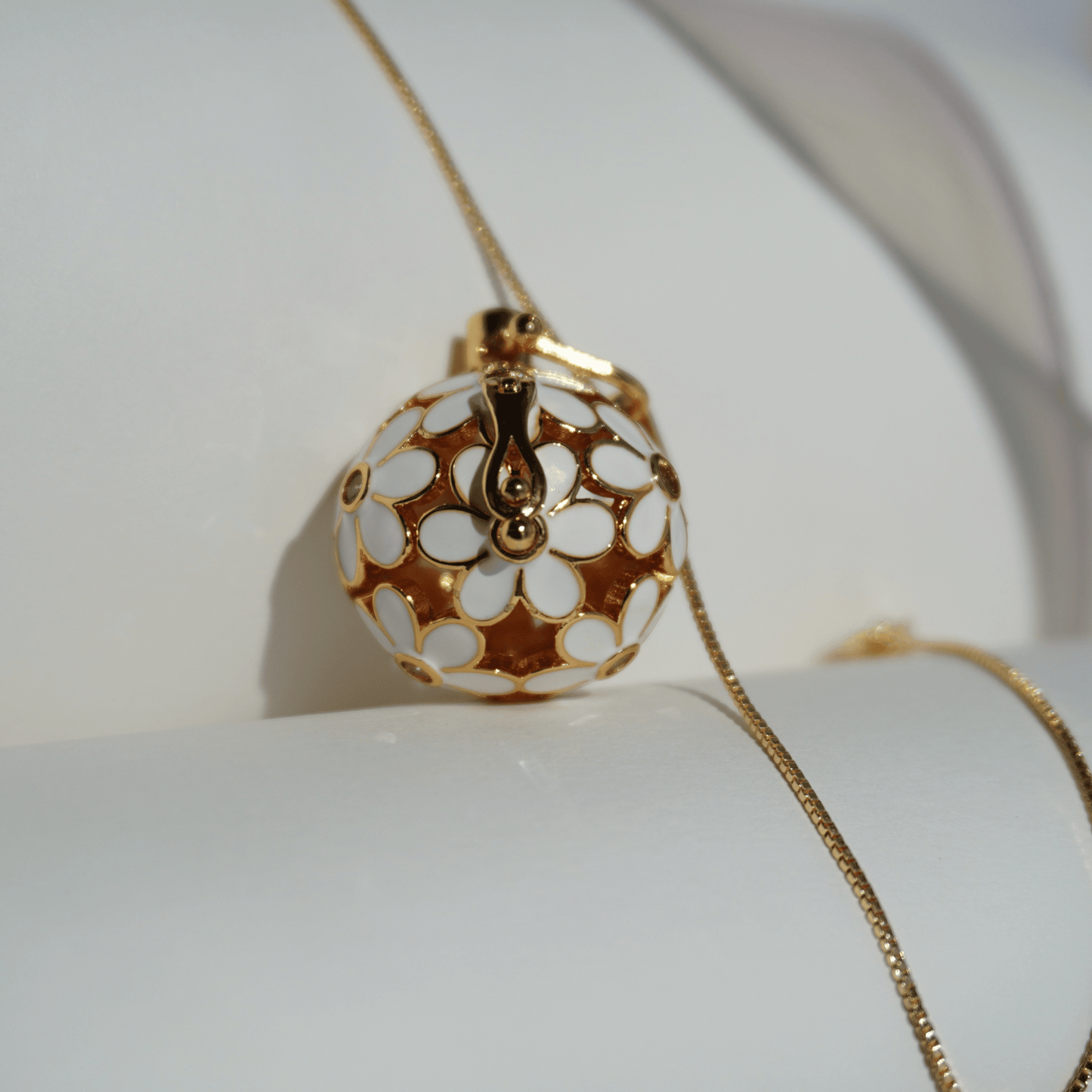Gold floral cage pendant holder for crystal beads_close_up_with_chain