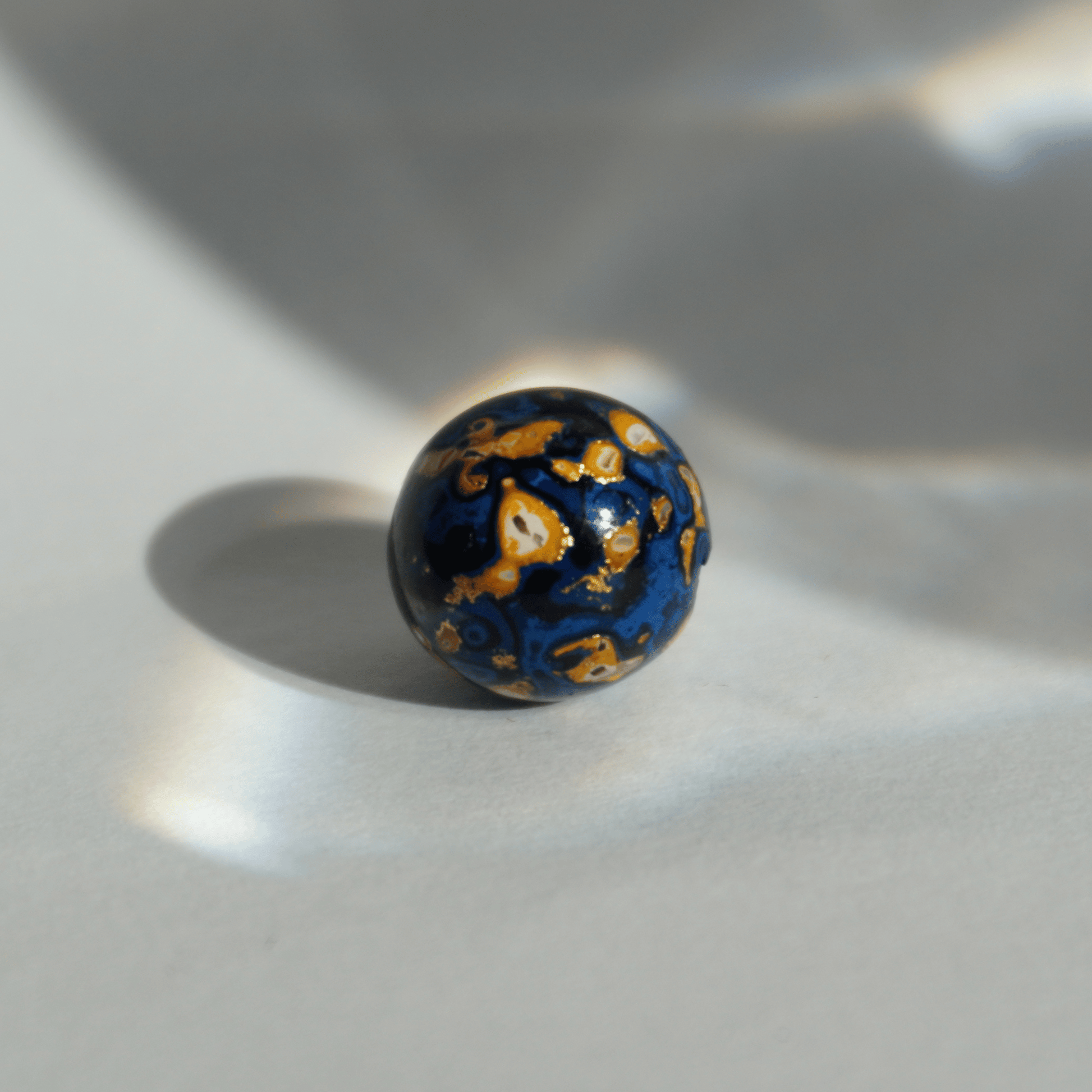 Indigo Desert ritual bead with celestial gold veining, handcrafted in plant-based resin_1