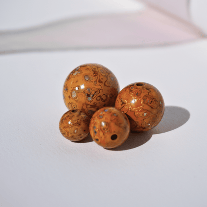 Sheen Gold ritual bead with soft golden matte glow in organic resin_cluster