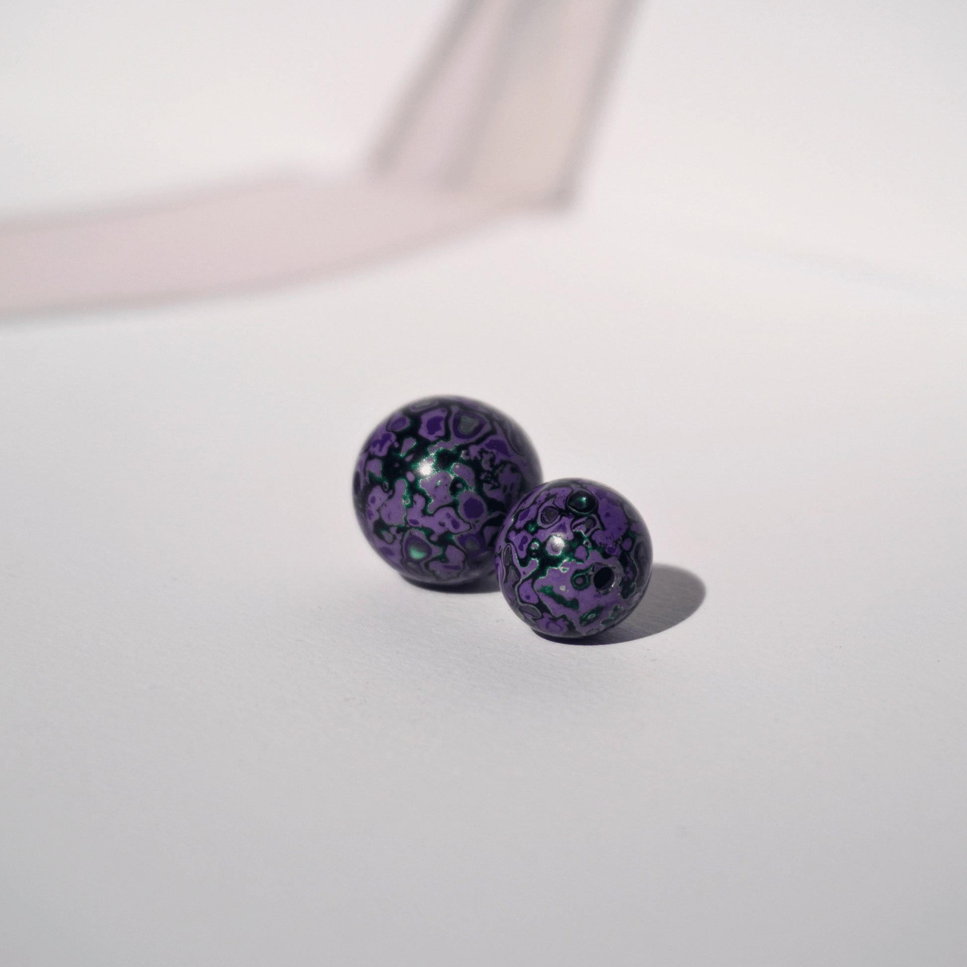 Wisteria Hedge ritual bead in lavender grey with soft glow, hand-polished resin_duo