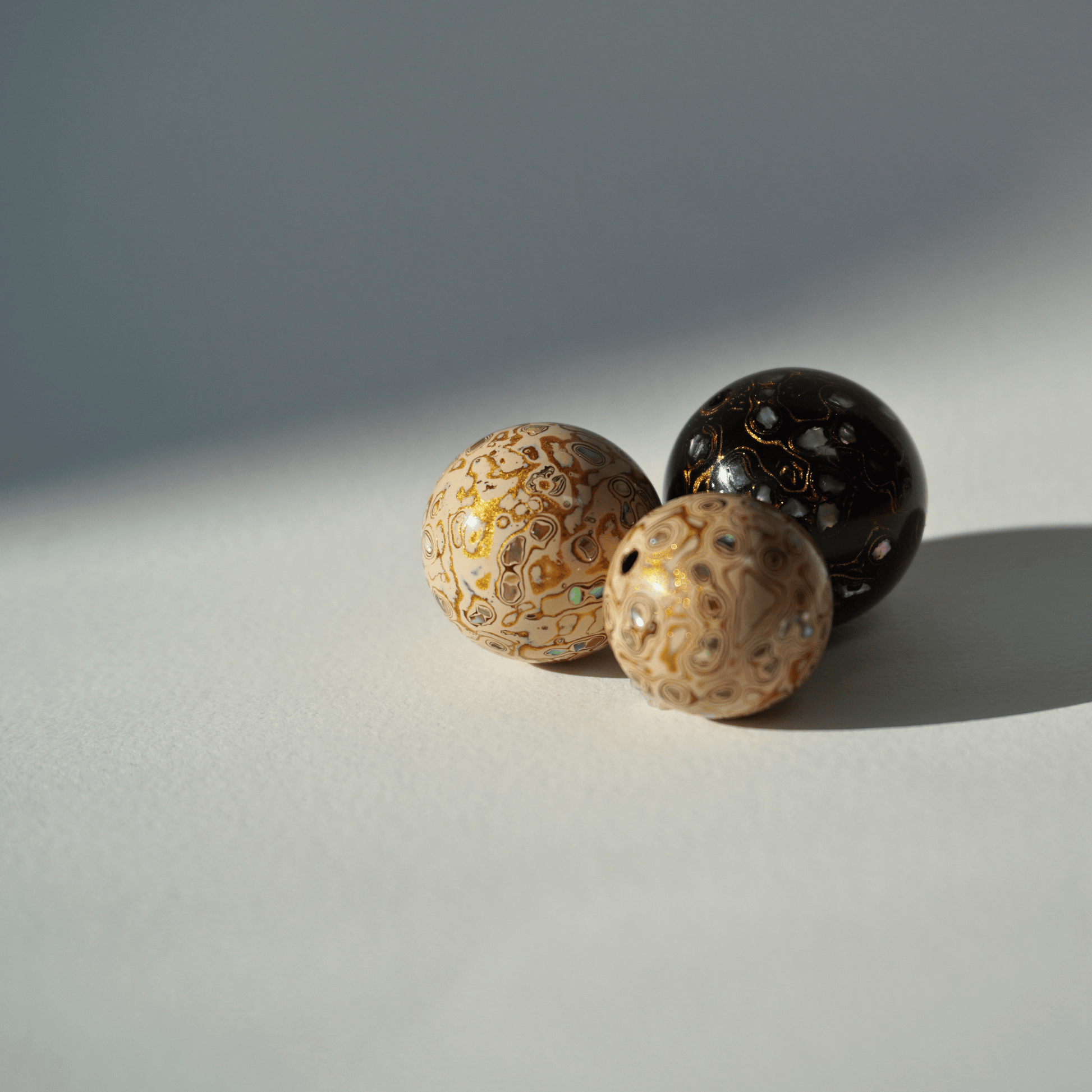 bead with high-gloss finish, hand-layered organic resin trio clustier