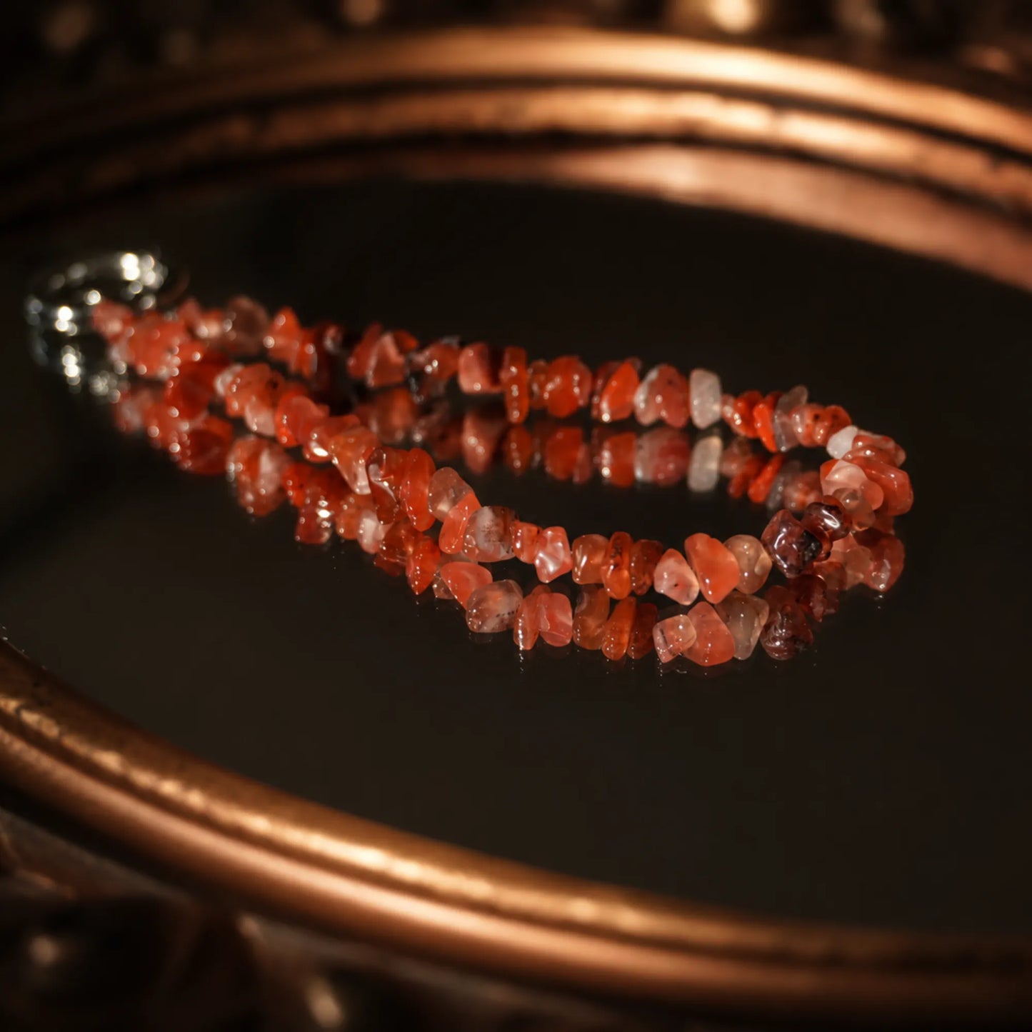 Natural red agate phone strap showing irregular stone textures