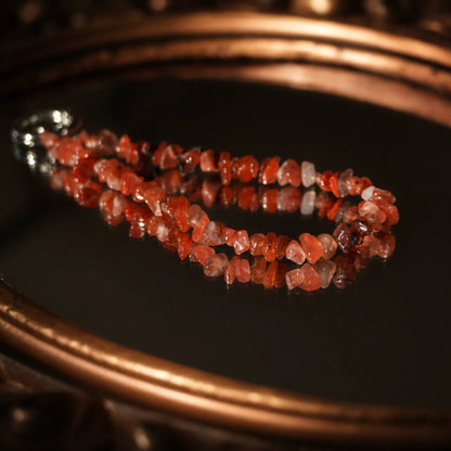 Natural red agate phone strap showing irregular stone textures