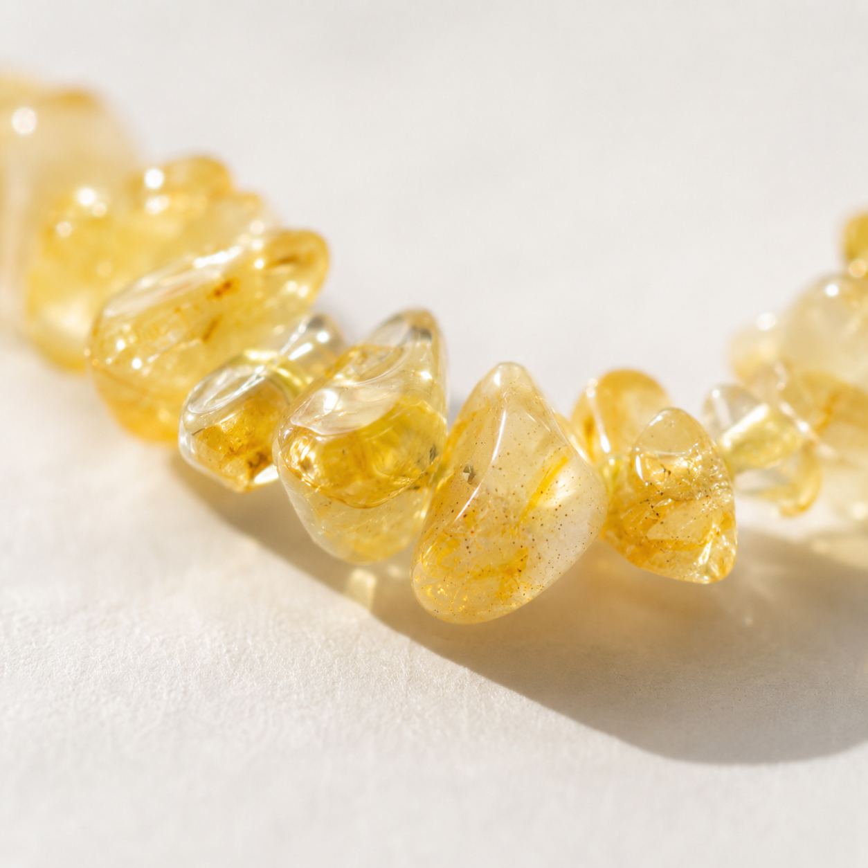 Close-up of genuine yellow quartz stone chips on handmade phone charm